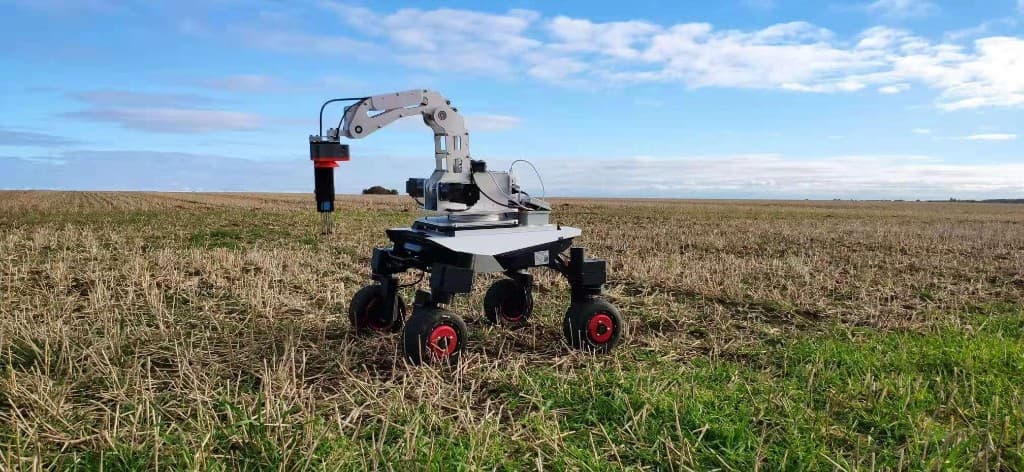 Soil monitoring robot probing harvested field for moisture and nutrient data