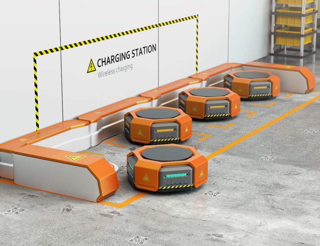 AMR fleet docked at a wireless charging station in a warehouse